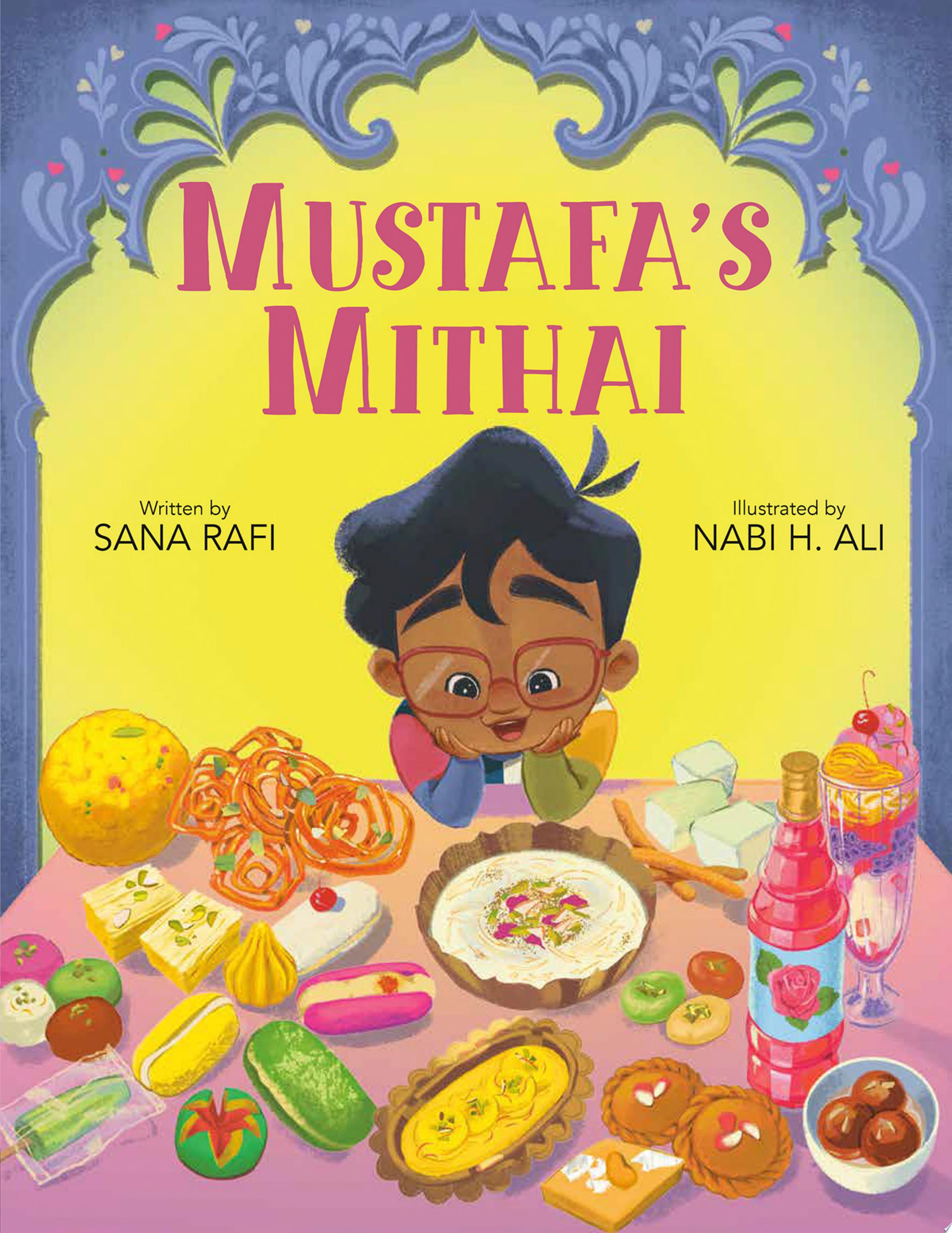 Mustafa sits and looks at a table filled with delicious food with a big smile on his face.