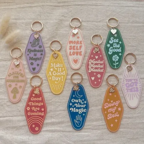 An assortment of "positive affirmation" keychains made with a Cricut machine.