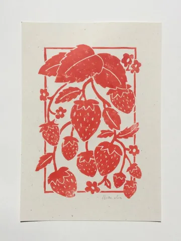 Screen printed design of a red strawberry plant on paper