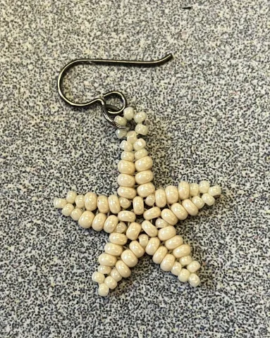 Star earring made from seed beads.