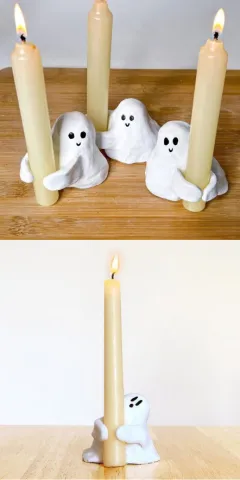 A few examples of air dry clay ghosts with painted details which are being used to hold thin candles.