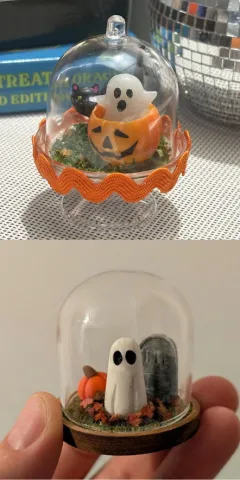 Two examples of miniature Halloween terrarium-style dioramas.